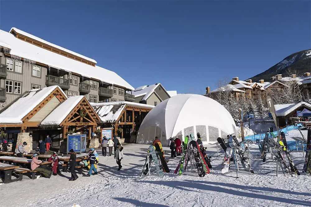 EJH Distribution outdoor ski resort with snow-covered buildings and ski equipment.