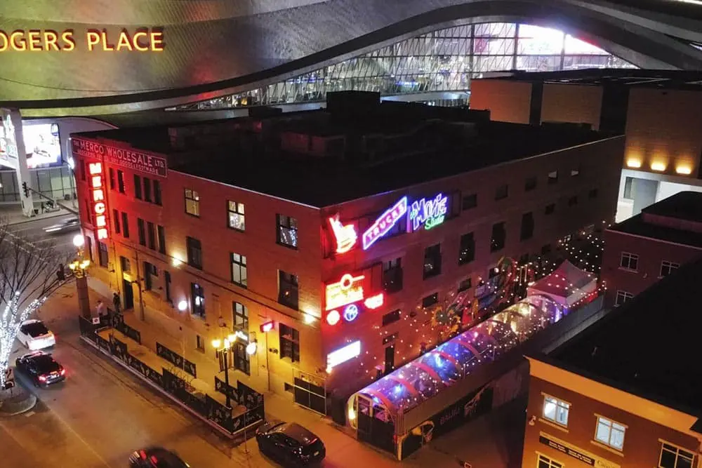 Vivid downtown nightlife scene with neon signs and vibrant lights at EJH Distribution office.