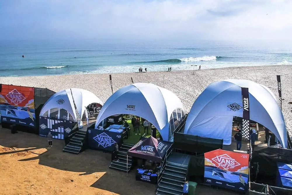 Vans event tents on beach, Vans branding, surf culture, mobile event setup, outdoor surf event.