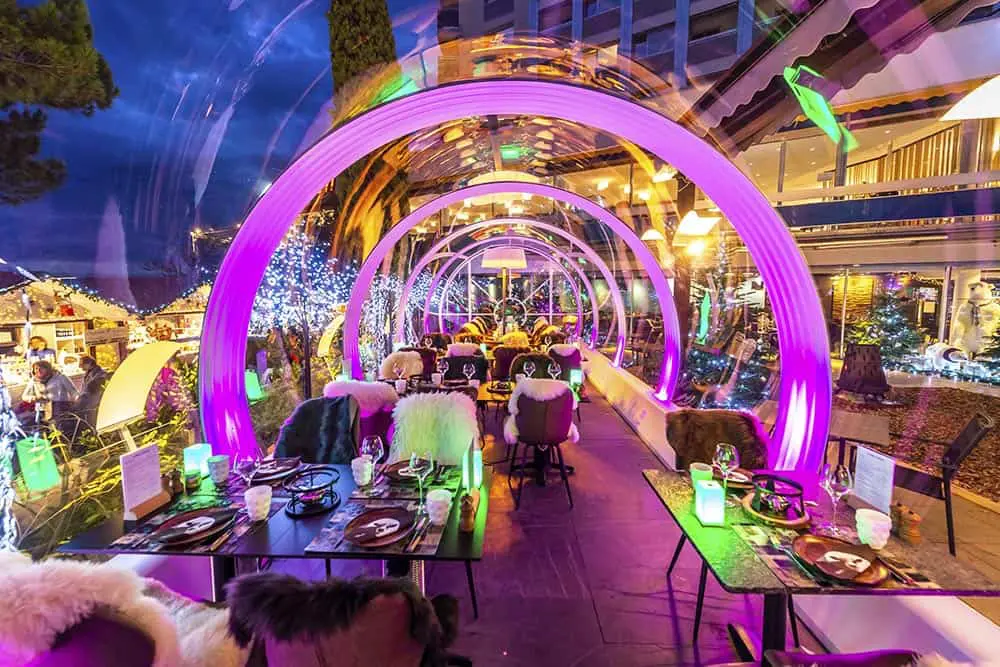 Vibrant outdoor dining space with colorful neon lights at EJH Distribution restaurant.