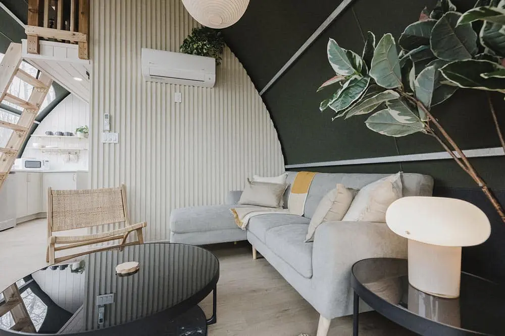 Cozy modern living room with stylish furniture and lush greenery for home interior design inspiration.