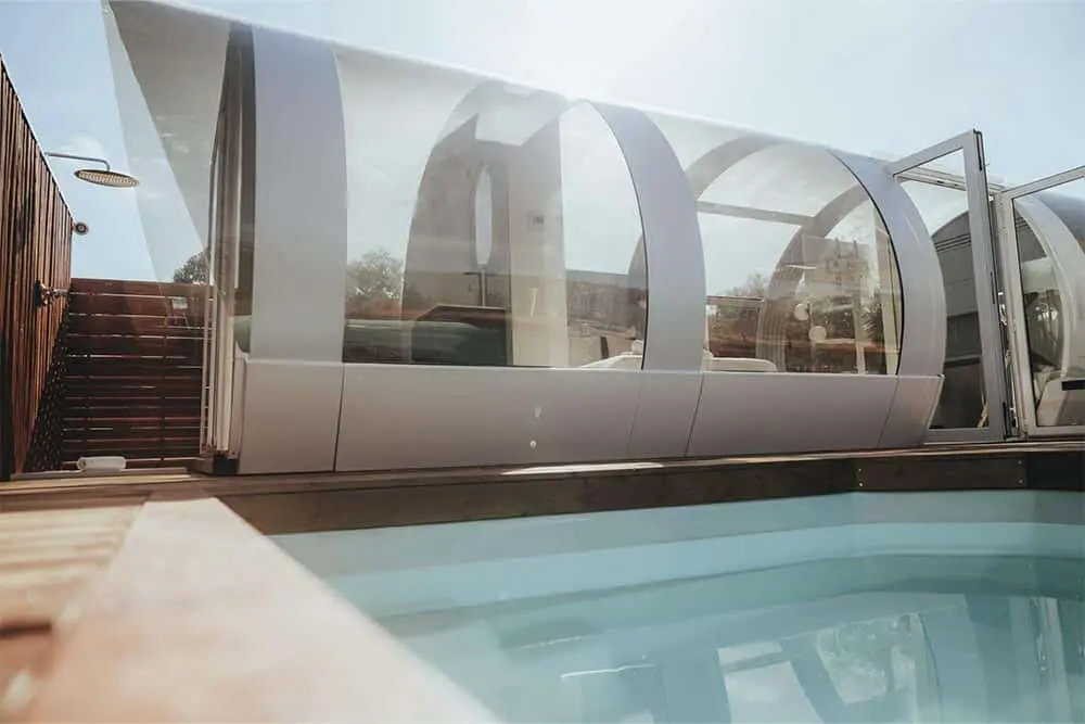 Modern glass pool enclosure with sleek design for backyard safety and style.