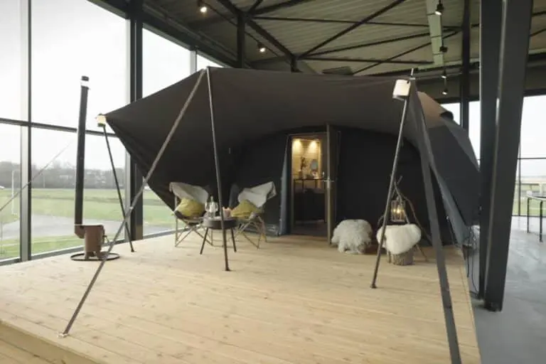 Modern luxury glamping tent setup with cozy furnishings and stylish decor for outdoor accommodation.