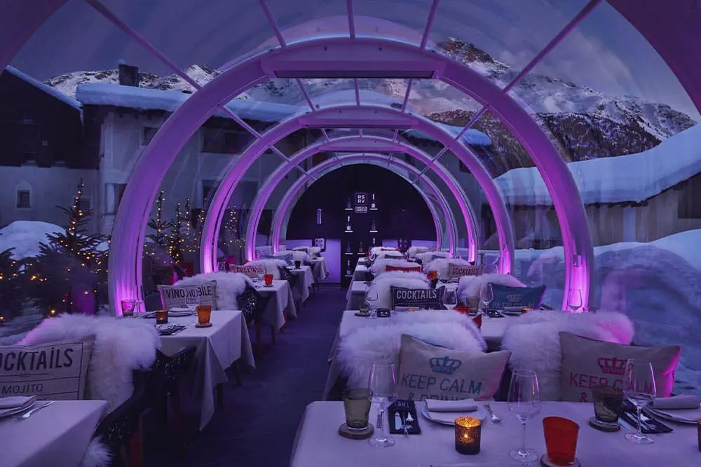 Aluminum tunnel outdoor dining with cozy winter decor and purple lighting at EJH Distribution.