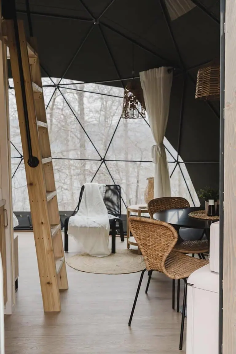 Modern glamping tent interior with stylish furniture and cozy decor, perfect for outdoor adventures.
