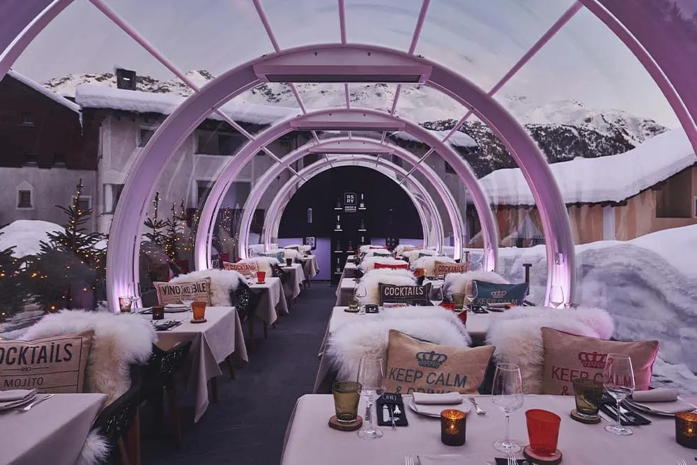 Warm winter outdoor dining area with illuminated pink arches at EJH Distribution.