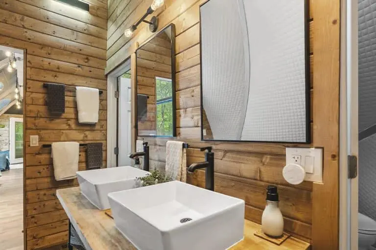 Modern bathroom with wood-paneled walls and contemporary fixtures.