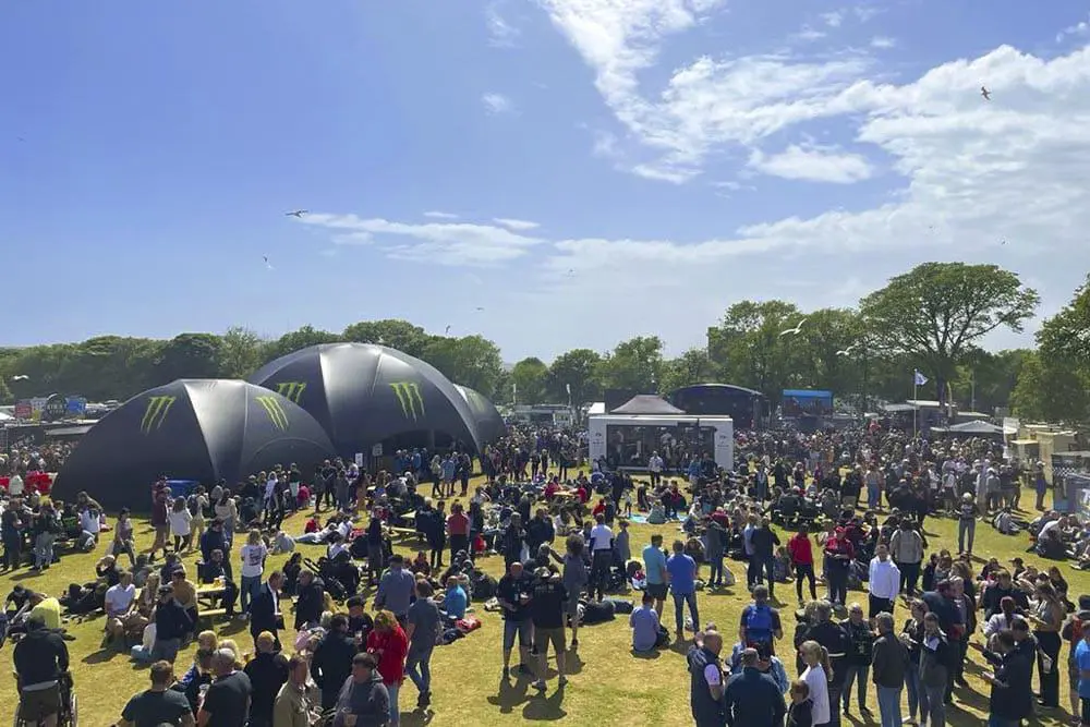 EJH Distribution event with large crowd and promotional Monster Energy tents.