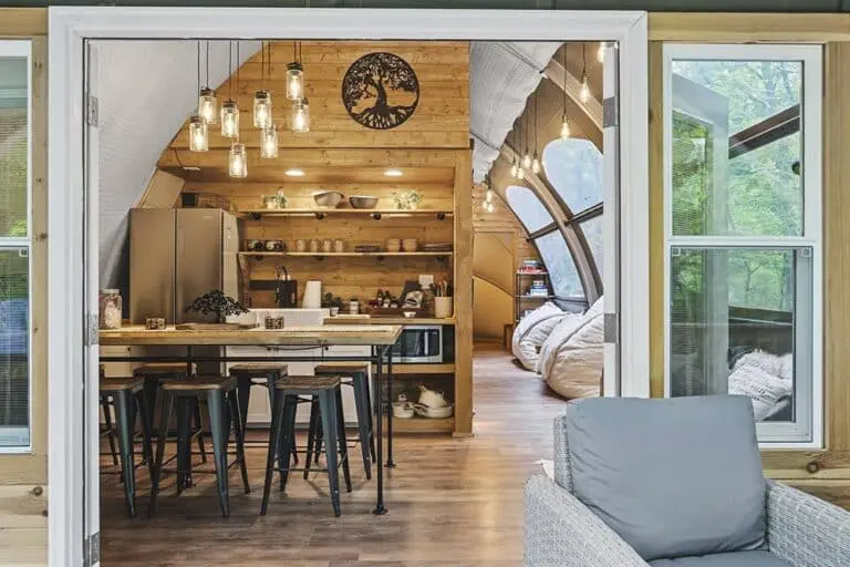 Modern tiny home interior with rustic wooden accents and open kitchen design.