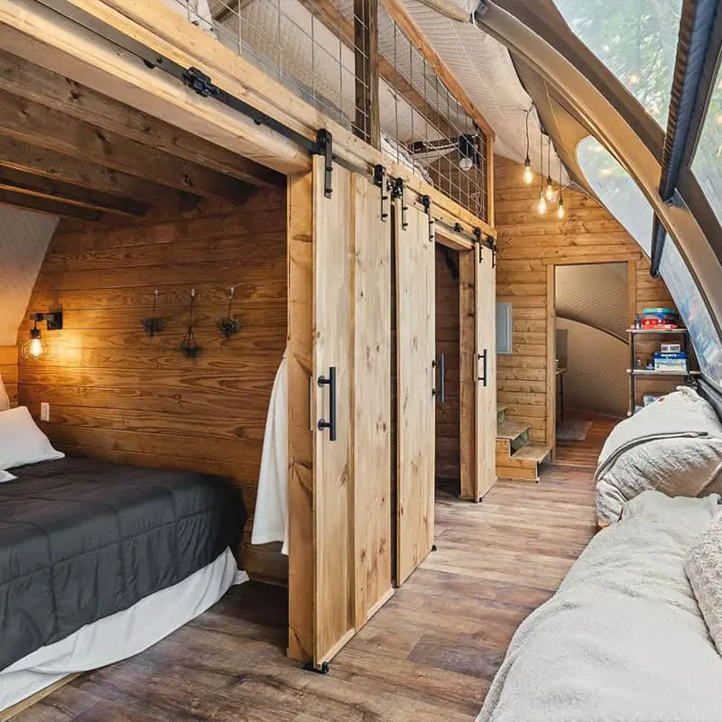 Upcycled wood barn door sliding system for rustic interior decor.
