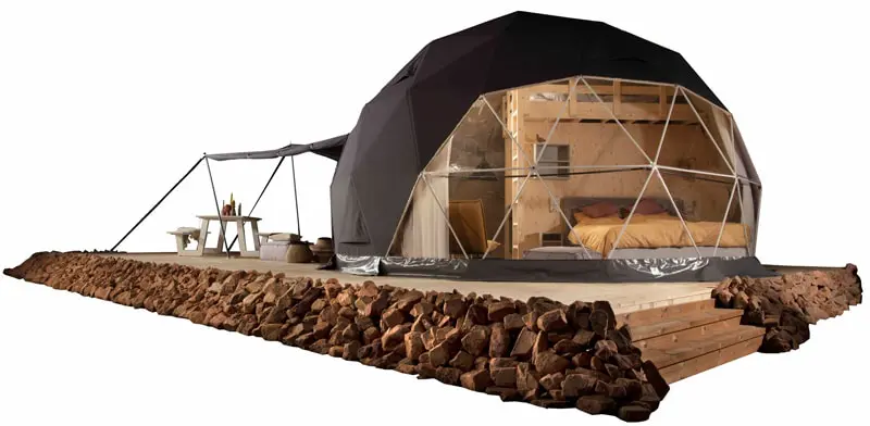 Eco-friendly geodesic dome outdoor tiny house with wooden deck and rustic interior.