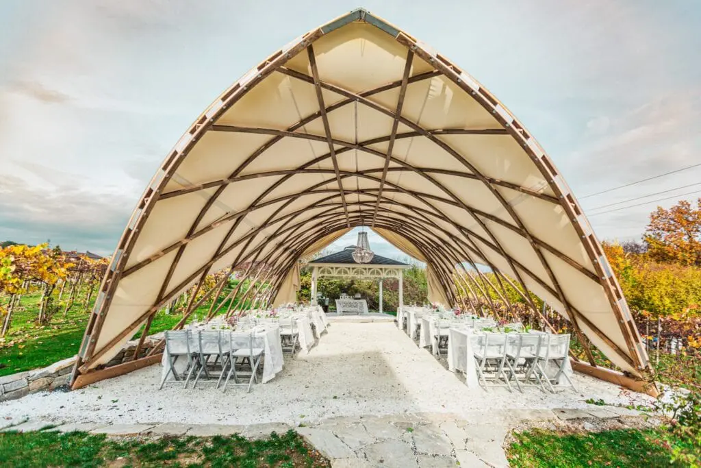 Modern event space with wooden dome structure for outdoor weddings or gatherings.