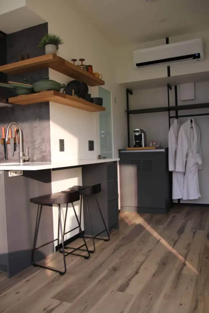 Modern kitchen with sleek cabinetry, open shelving, and high-end appliances, showcasing contemporary design and functionality ideal for home and hospitality distributions.