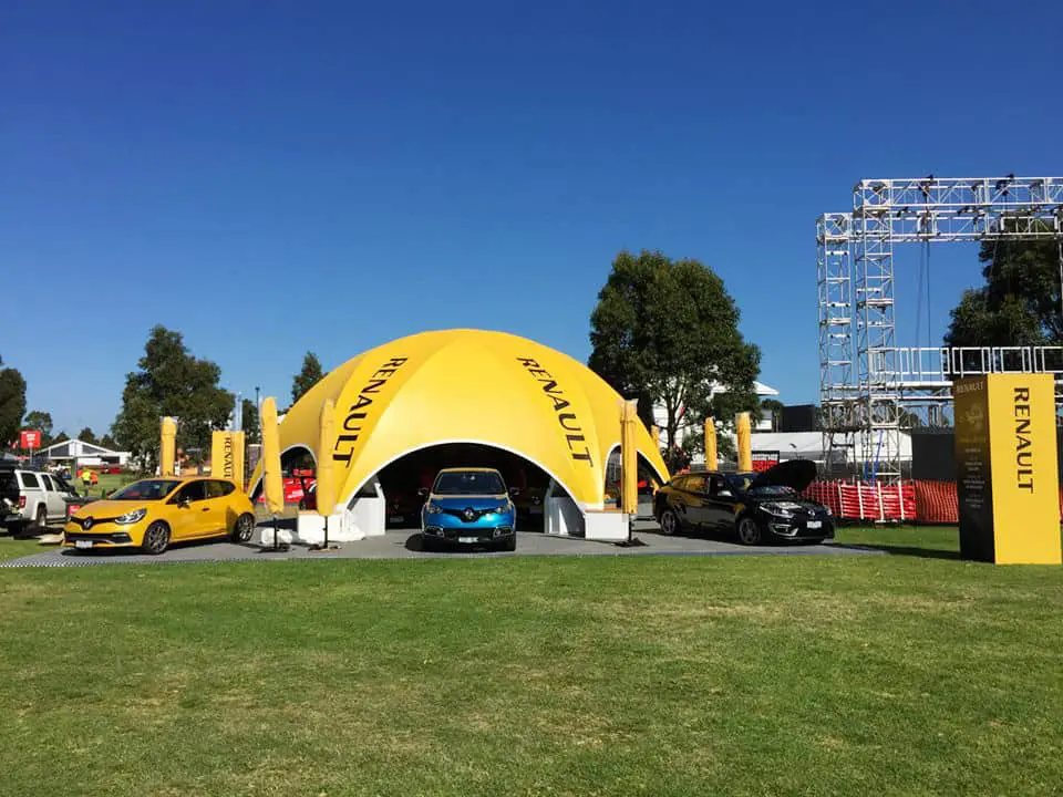 Renault experiential activation with branded tents and cars at outdoor event, showcasing new models and engaging visitors in a vibrant setting.