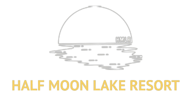Serene sunset over Half Moon Lake with calm waters reflecting the vibrant sky, surrounded by lush nature, ideal for relaxation and outdoor activities.