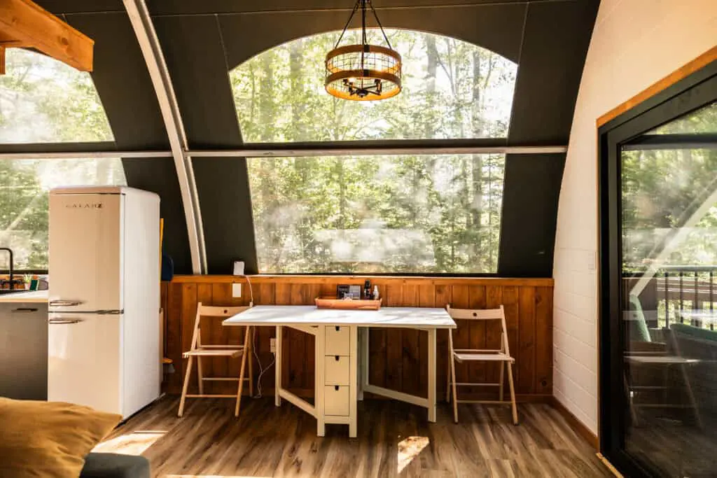 Cozy interior with large windows and wooden accents.