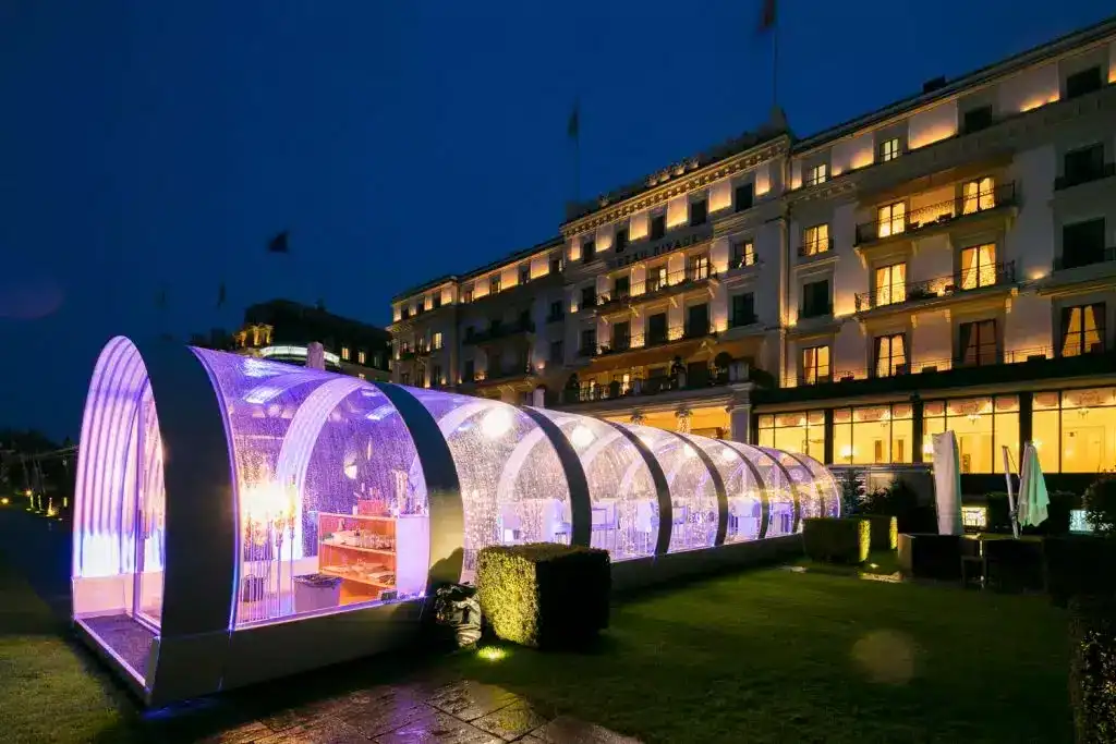 LED-lit glass greenhouses for events at EJH Distribution outdoor venue.