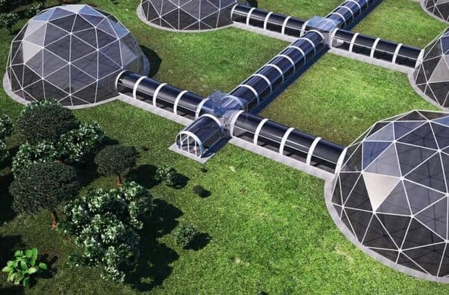 Futuristic glass-domed structures connected by walkways in a lush green landscape for eco-friendly innovations.