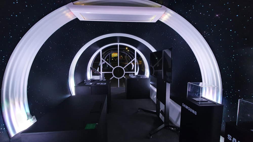 Futuristic space-themed exhibit with modern electronics and galaxy decor at EJH Distribution.