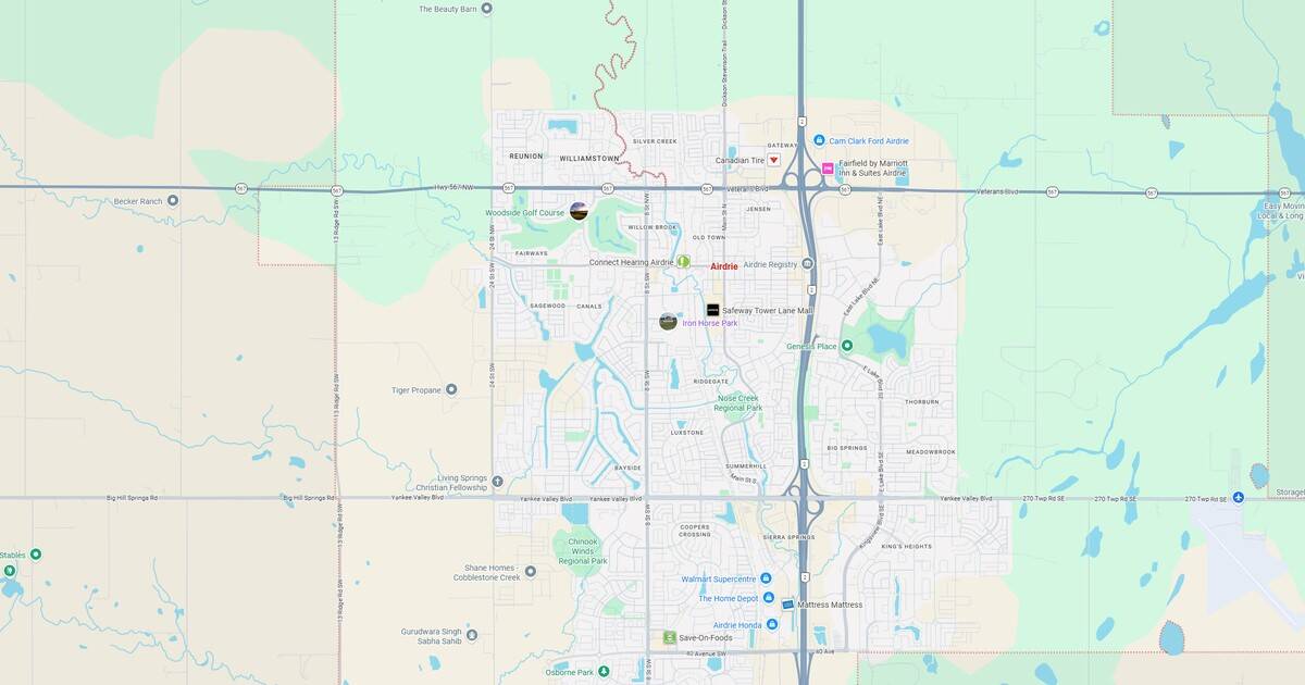 Map of a suburban city with roads, parks, and water bodies at sunset.